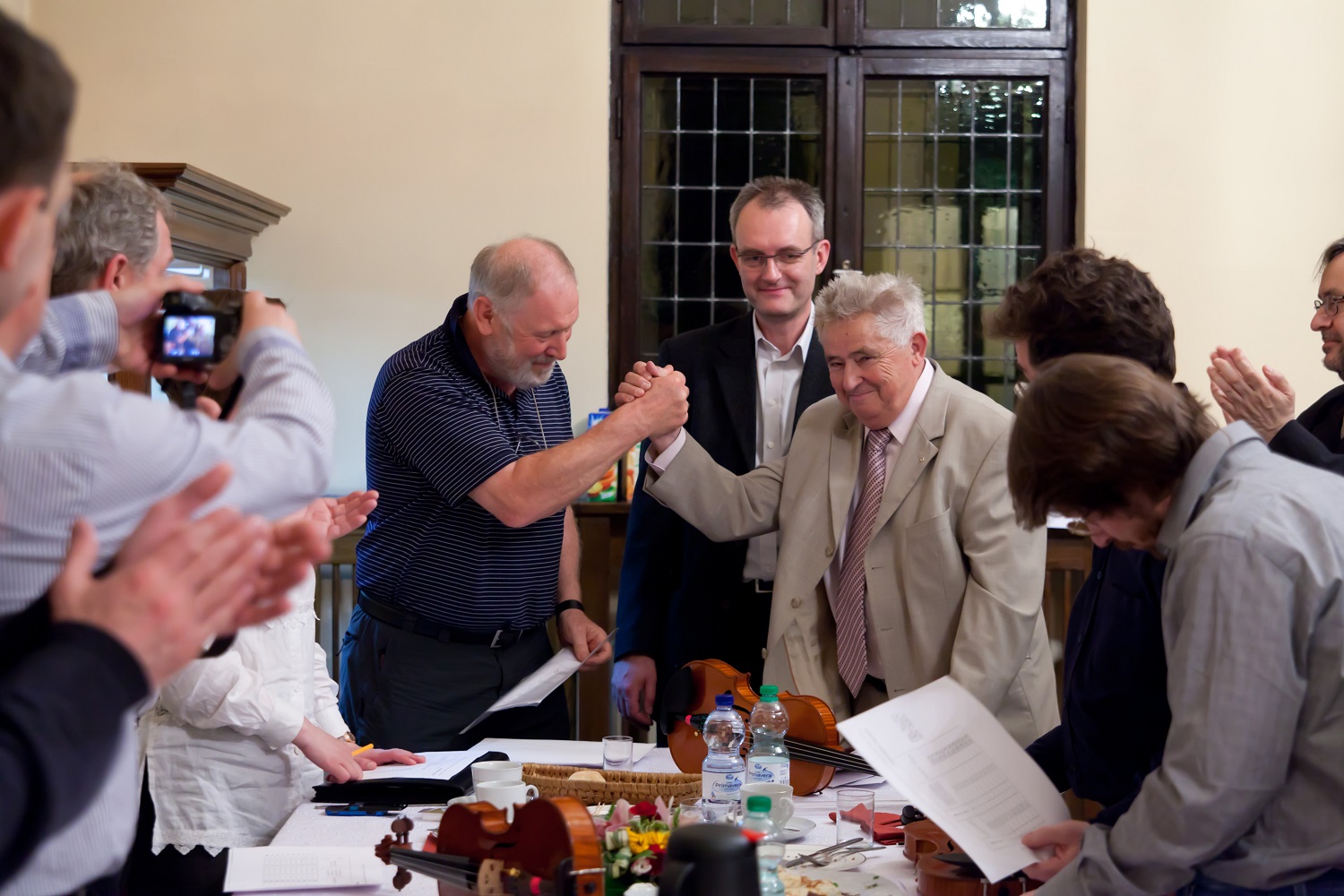 Shortly after opening of the envelopes with the names of the winners. Handshake of the Chairman of the Jury Roger Hargrave and Director Andrew Wituski. Behind them – competition interpreter Waldemar Łyś.