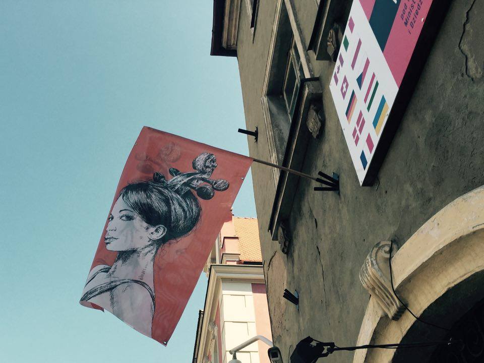 Banner and a flag with graphics designed by Andrzej Pągowski hanging on a building of Museum of Musical Instruments in Poznań (06.05.2016)
